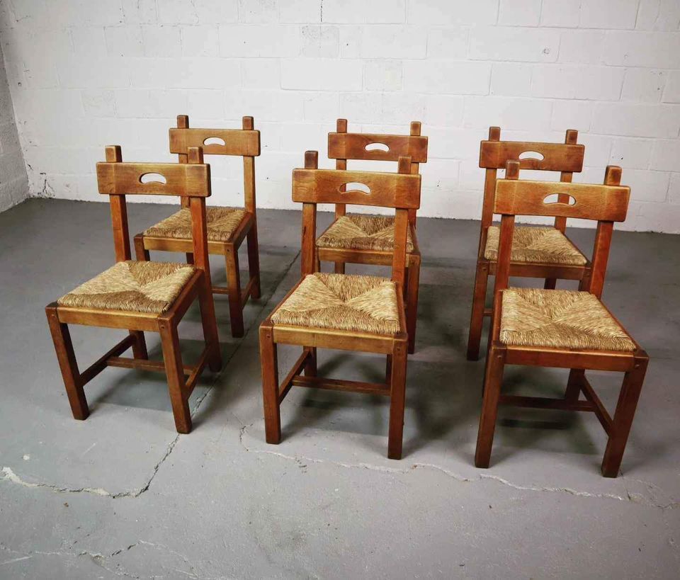 Six brutalist, rustic dining chairs