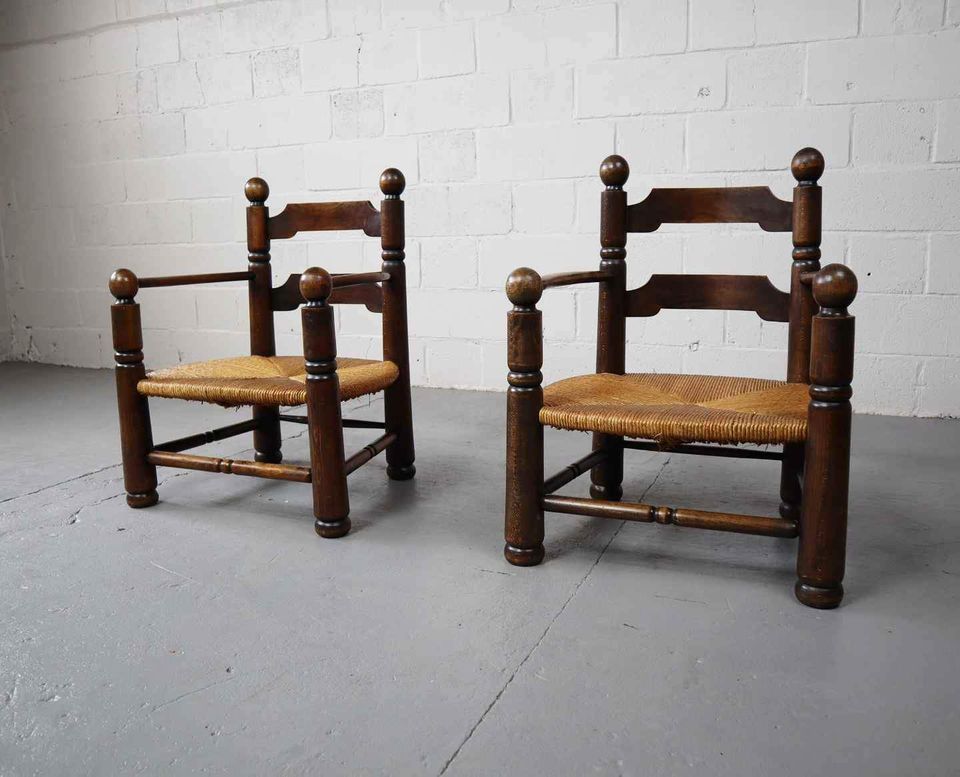 Pair of oak armchairs by Charles Dudouyt